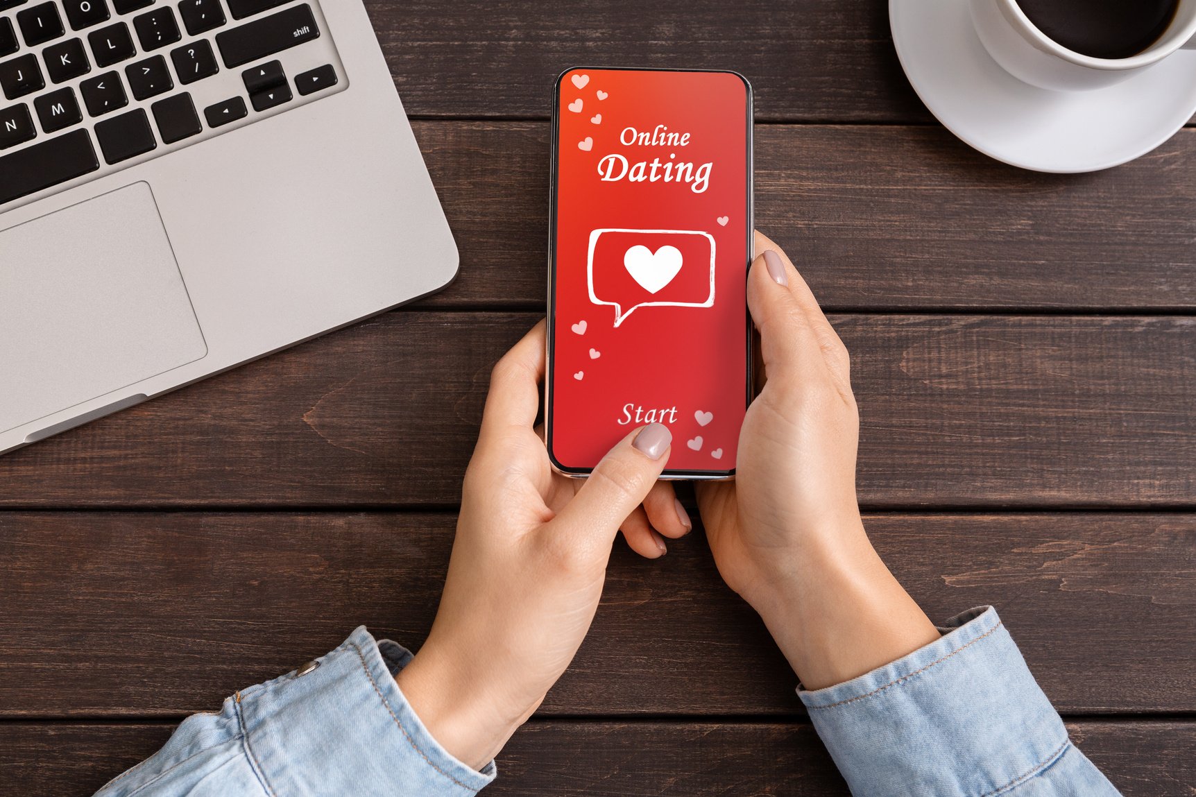 Close Up Of Woman's Hands Downloading Dating App On Smartphone