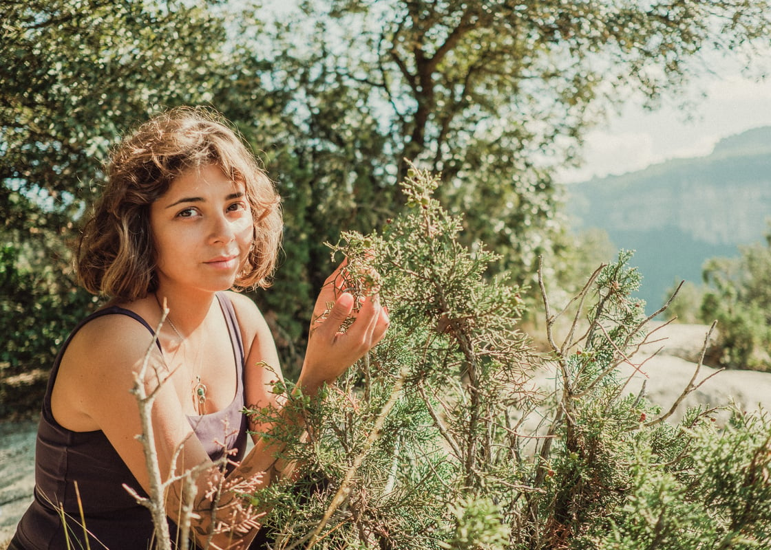 Woman Touching Grass Shrub